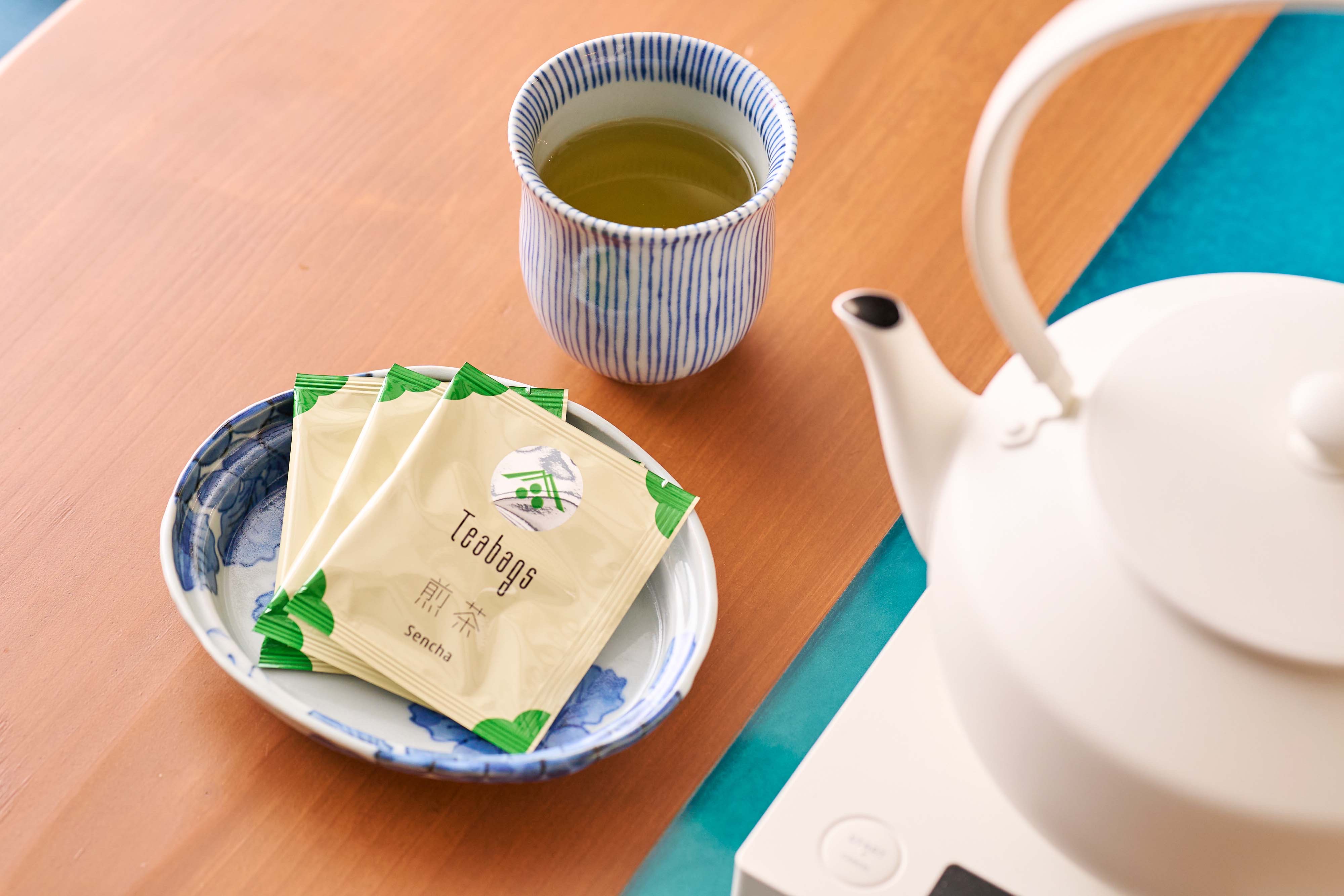 Japanese tea and a teapot with a packaged snack