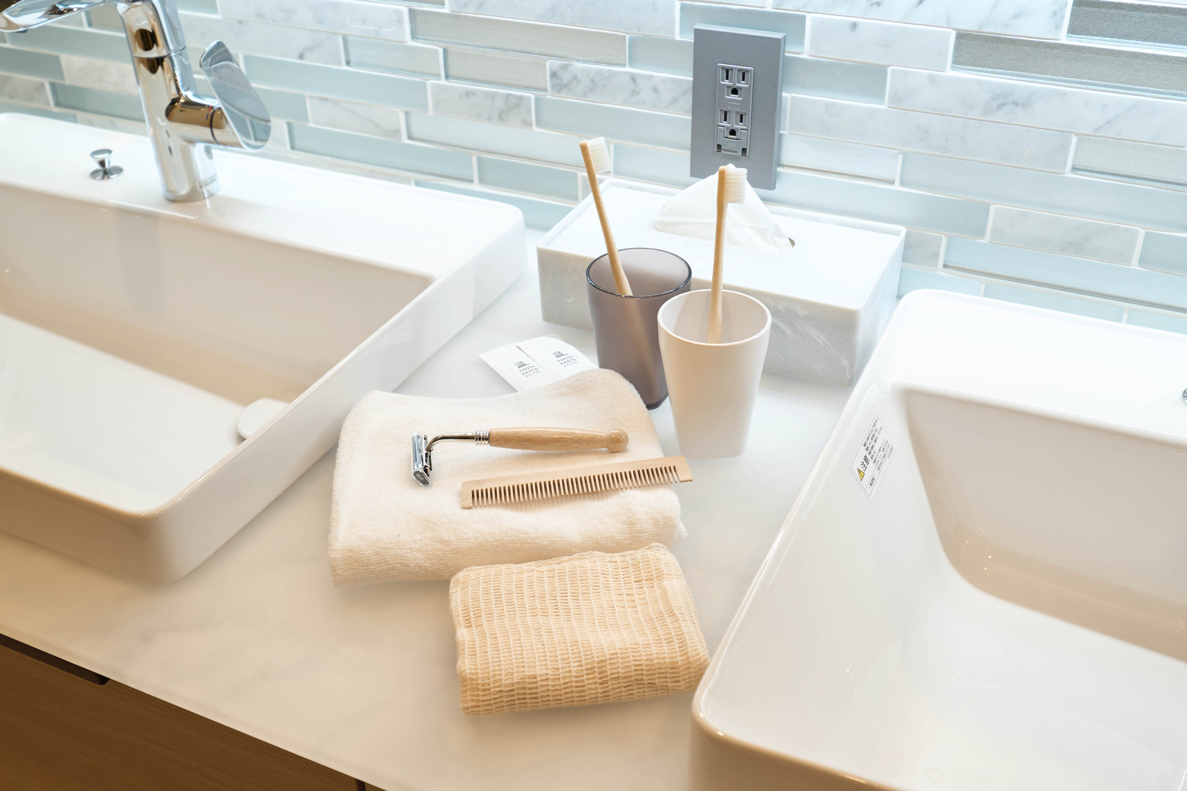 Clean bathroom amenities beside a bright window