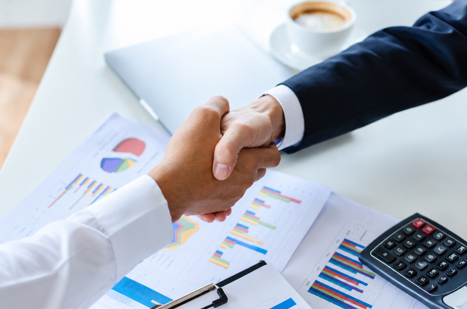 A handshake over business documents